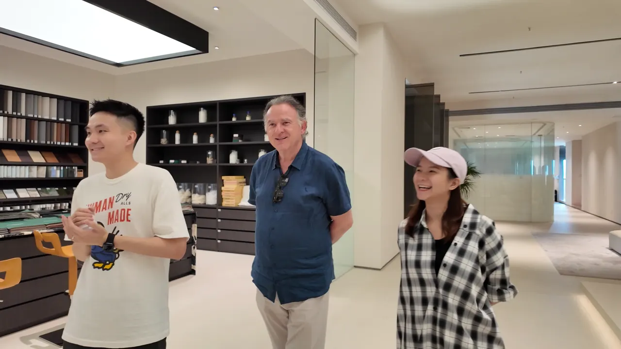 Three people speaking in a furniture showroom